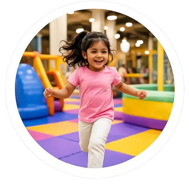 A girl running across the soft play floor at Playport